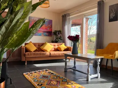 a living room with a couch and a table at Healing Pastures Farm in Llanbrynmair