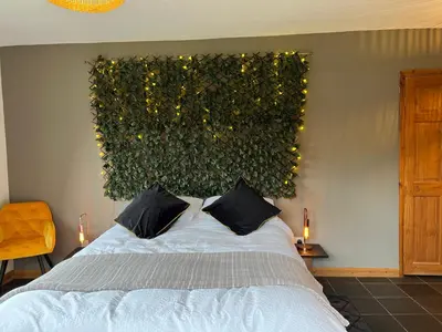 a bedroom with a bed and a green wall at Healing Pastures Farm in Llanbrynmair