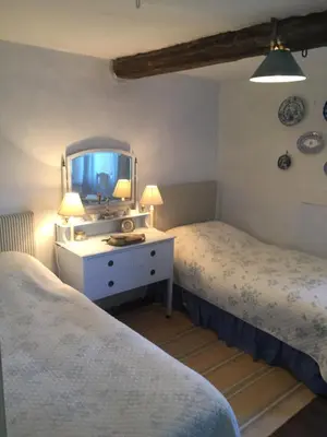 a bedroom with two beds and a mirror at Lower House Farm B&B, Herefordshire in Hergest