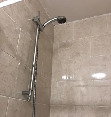 a shower with a shower head in a bathroom at The Bell Hotel in Newtown