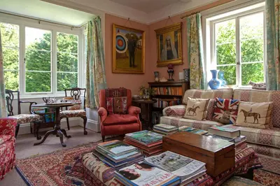 a living room with a couch and a table at Lower Buckton Country House in Leintwardine