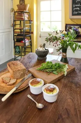 a wooden table with bread and other food on it at Lower Buckton Country House in Leintwardine