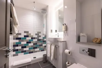 a white bathroom with a sink and a toilet at The Feathers Hotel in Ludlow