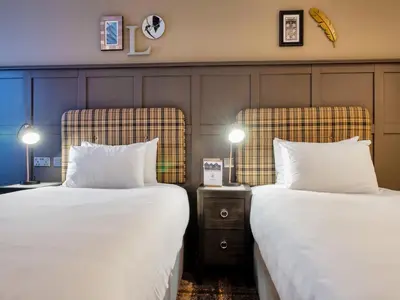 two beds sitting next to each other in a room at The Feathers Hotel in Ludlow