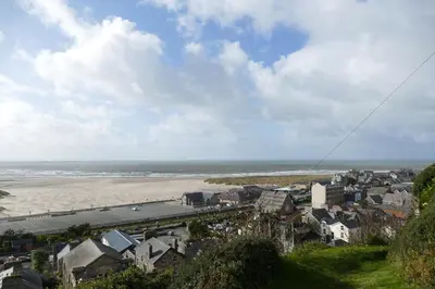 a view of a city and a beach with houses at Bae Abermaw Hotel in Barmouth