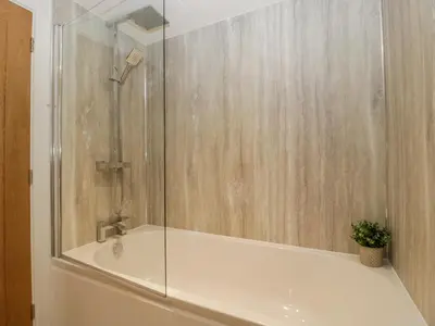 a bathroom with a shower with a glass door at The Dutch Barn in Leominster