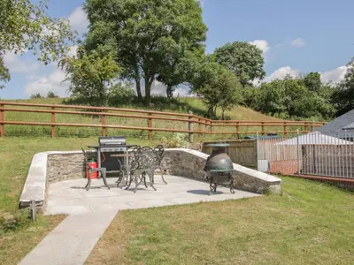 a patio with a grill and a grill at The Boundary Annex in Bishops Castle