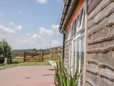 a building with a window and a wooden fence at The Boundary Annex in Bishops Castle