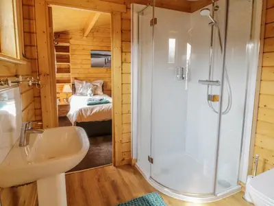 a bathroom with a shower and a sink in a room at Manor Farm Lodges - Red Kite Lodge in Newtown