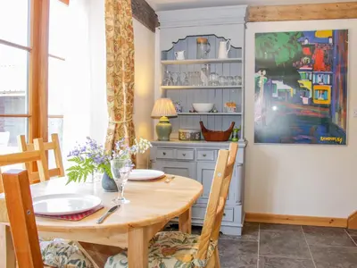 a dining room with a wooden table and chairs at High Grove in Ludlow