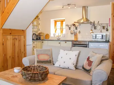 a living room with a couch and a kitchen at High Grove in Ludlow