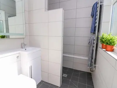 a bathroom with a toilet and a sink and a mirror at Ty'r Orsaf in Builth Wells