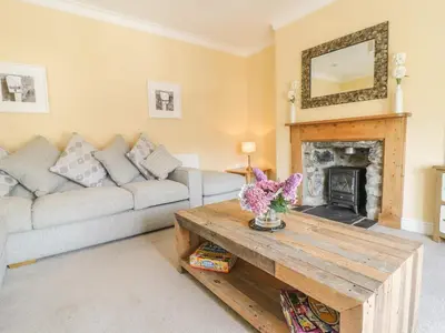 a living room with a couch and a fireplace at Angorfa in Llanbedr