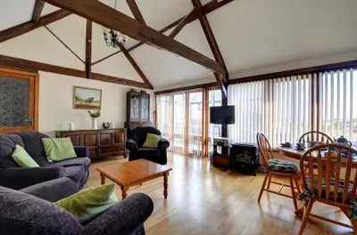 a living room with couches and a table at 2 Bed in Welshpool oc-wab256 in Berriew