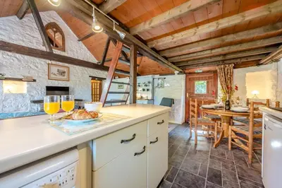 a kitchen with a counter with two glasses of orange juice at 2 Bed in Llandeilo oc-waw313 in Talley