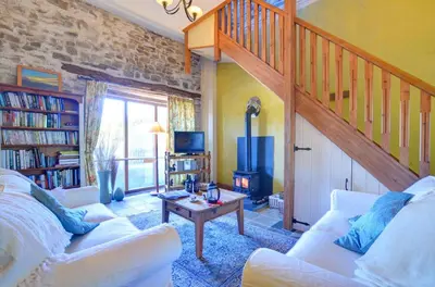 a living room with two white couches and a staircase at 2 Bed in Crugybar oc-waw323 in Llansawel