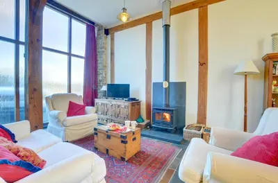 a living room with white furniture and a fireplace at 2 Bed in Crugybar oc-waw324 in Llansawel
