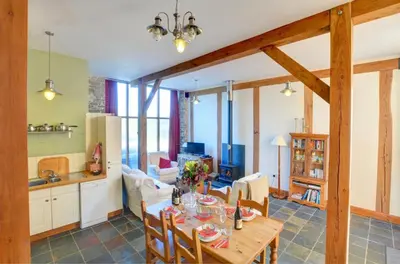 a kitchen and living room with a table and chairs at 2 Bed in Crugybar oc-waw324 in Llansawel