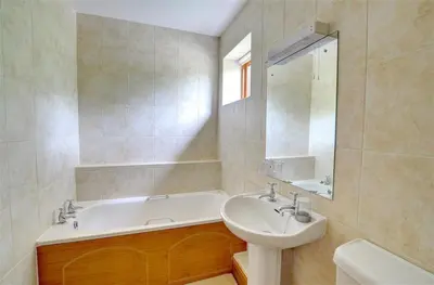 a bathroom with a sink and a bath tub and a sink at 2 Bed in Tywyn oc-wah595 in Llanegryn