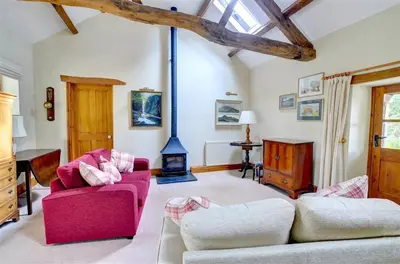 a living room with two couches and a fireplace at 2 Bed in Tywyn oc-wah595 in Llanegryn