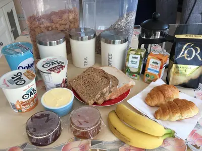 a table topped with different types of breakfast foods at Birchwood House in Church Stretton