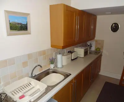 a kitchen with a sink and a counter top at Birchwood House in Church Stretton