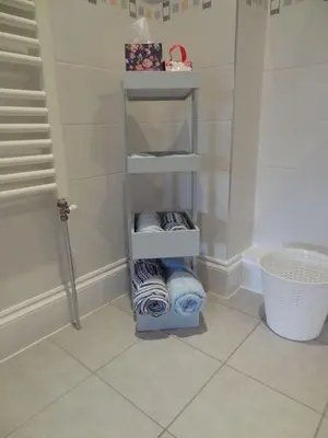 a bathroom with a towel rack with towels at Birchwood House in Church Stretton