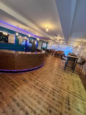 a lobby with a bar and tables and chairs at Hampton Hotel & restaurant in Llandrindod Wells