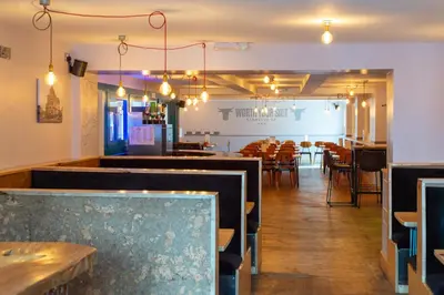 a restaurant with a dining room with tables and chairs at Hampton Hotel & restaurant in Llandrindod Wells