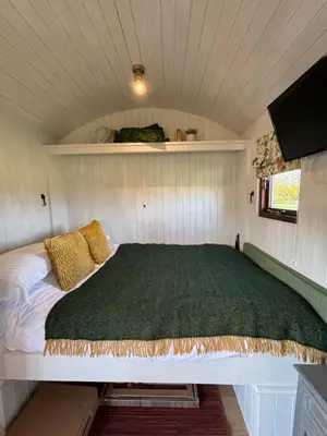 a bedroom with a bed in a small room at Bron Hafren in Montgomery