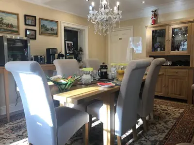 a dining room with a wooden table and chairs at Bron Hafren in Montgomery