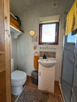 a small bathroom with a toilet and a sink at Bron Hafren in Montgomery