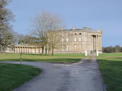 a driveway leading to a large brick building at Pepperpot Lodge in Baschurch