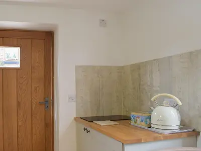 a kitchen counter with a white tea kettle on it at Pepperpot Lodge in Baschurch