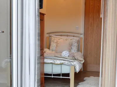 a small bedroom with a bed with a canopy at Penmaen in Talgarth