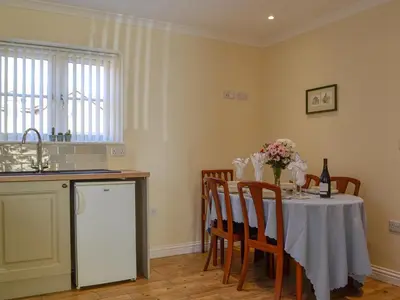 a kitchen with a table with a white table cloth at Penmaen in Talgarth