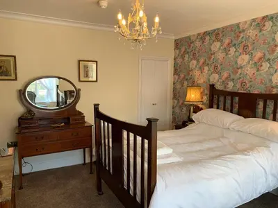 a bedroom with a large bed and a mirror at The Royal in Barmouth