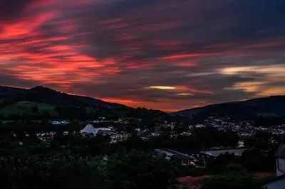 a view of a town under a cloudy sky at sunset at Llangollen Shepherds Huts in Llangollen