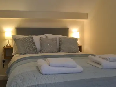 a bed with two white pillows on top of it at Pen Parc in Bryn-crug