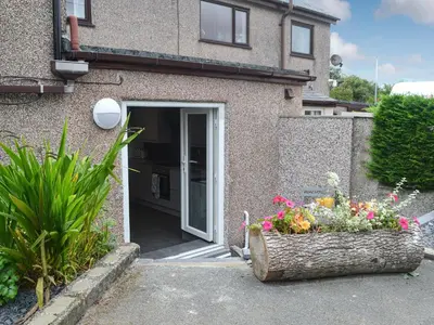 a house with two flower boxes in front of a door at Pen Parc in Bryn-crug