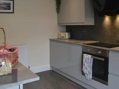 a kitchen with a stove and a counter top at Pen Parc in Bryn-crug