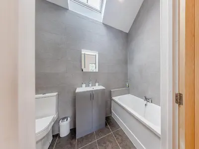 a bathroom with a tub and a toilet and a sink at Ty Felin - Uk12744 in Acrefair
