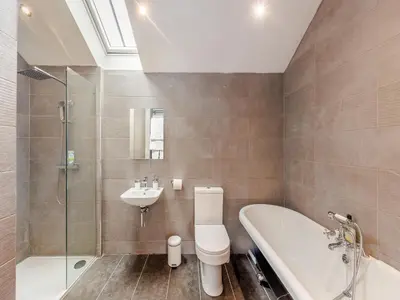 a bathroom with a tub and a toilet and a sink at Ty Felin - Uk12744 in Acrefair