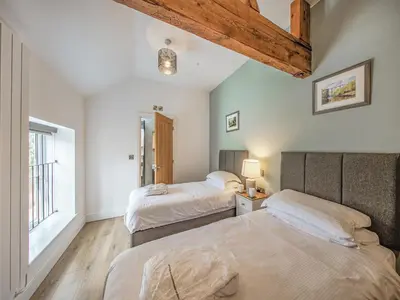 a bedroom with two beds and a window at Cor Tarw - Uk12743 in Acrefair