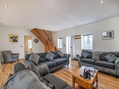 a living room with two couches and a table at Cor Tarw - Uk12743 in Acrefair