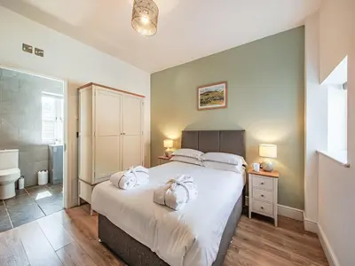 a bedroom with a bed with two towels on it at Cor Tarw - Uk12743 in Acrefair