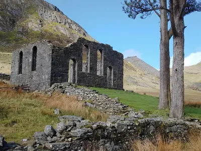 an old church on the side of a hill at Moelwyn View Cottage in Blaenau-Ffestiniog