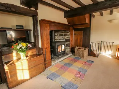 a living room with a fireplace and a television at Little Bicton in Craven Arms