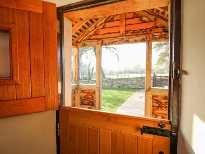 an open door to a room with a window at Little Bicton in Craven Arms