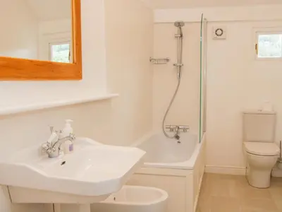 a bathroom with a sink and a shower and a toilet at The Old Farmhouse, Upper Pitts in Knighton
